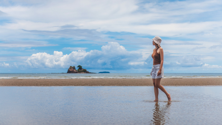 A woman walking on the beach of Mae Phim, Thailand