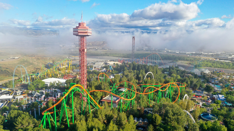 Aerial view of Six Flags Magic Mountain in Valencia, California with prominent roller coasters and mountains in the distance