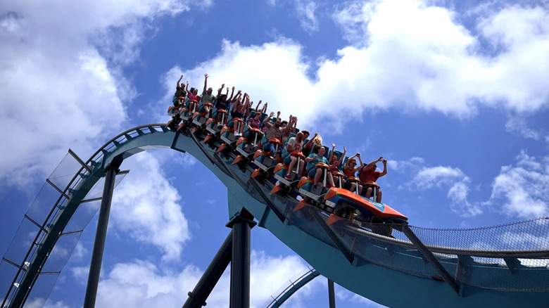 Riders put their hands up on a roller coaster at Six Flags Over Georgia