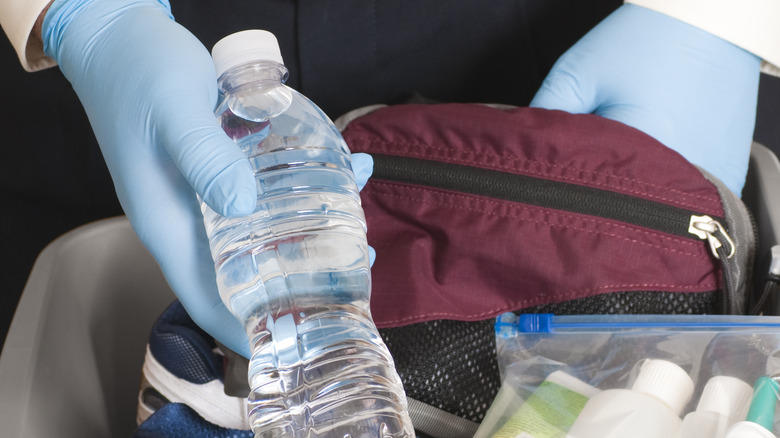 TSA agent finding bottle of water
