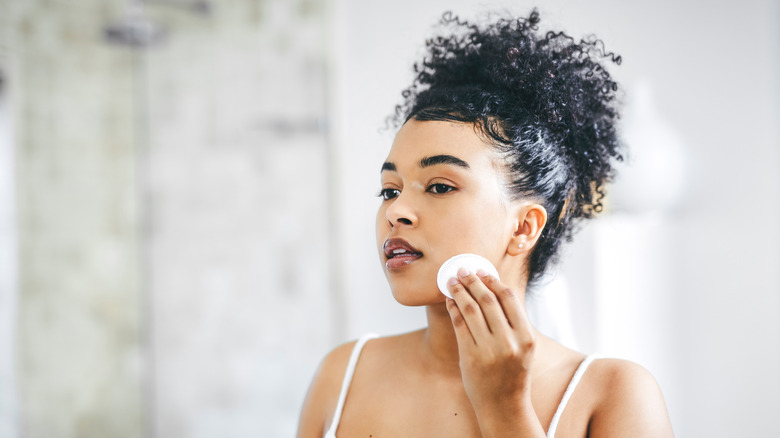 Woman using makeup remover 