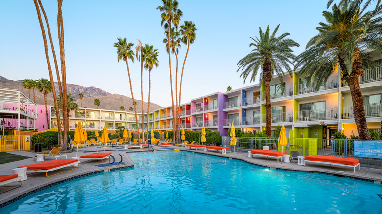 Colorful hotel pool with palm trees in Palm Springs