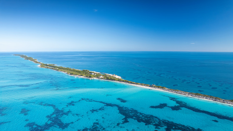 An aerial drone shot of Rose Island in The Bahamas, surrounded by bright turquoise waters