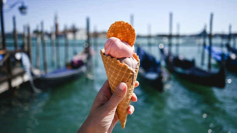 Hand holding up a gelato cone