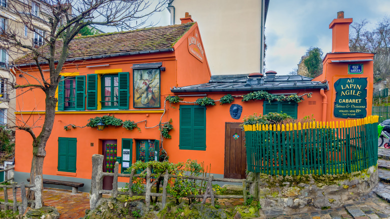 Orange exterior of Au Lapin Agile cabaret in Montmartre.