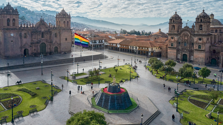 A public square in Cuzco, Peru, featuring colonial-style churches and buildings
