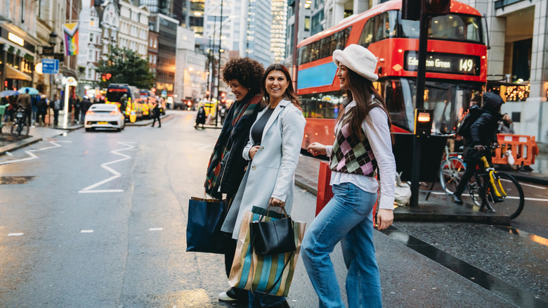 Three women crossing a street in London, England