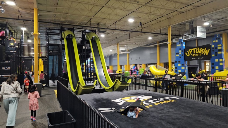 Children and families play on Slick City Action Park's indoor slides.