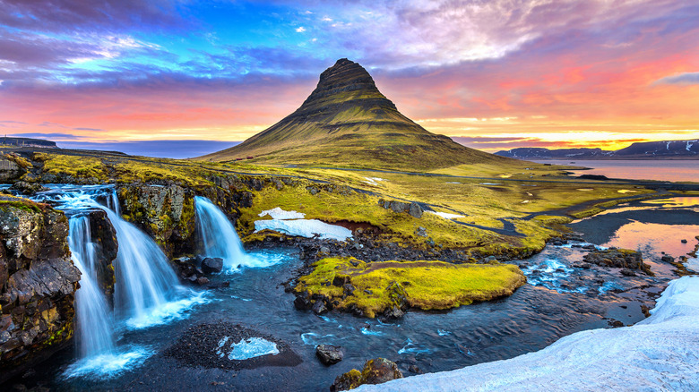 Colorful sunrise on Kirkjufellsfoss waterfall. Amazing morning scene near Kirkjufell volcano, Iceland, Europe.