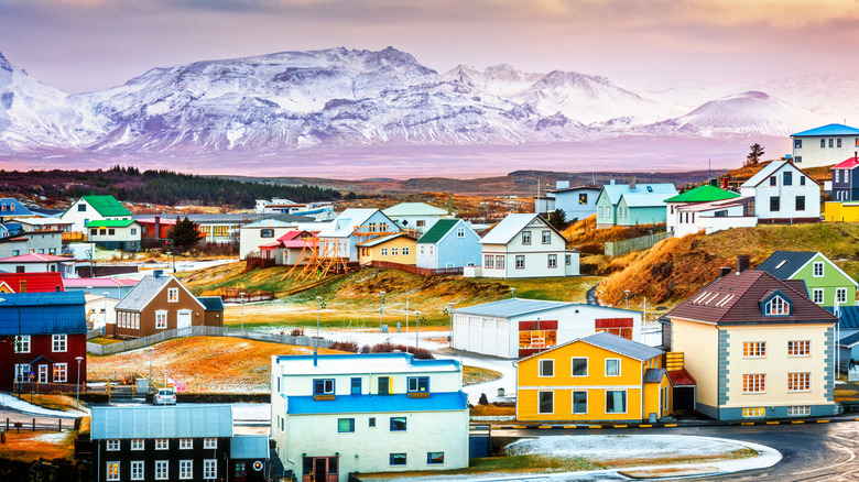The colorful buildings of Stykkisholmur town in western Iceland, with the glacier in the background.