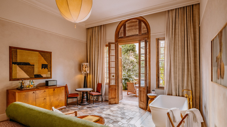 The brightly-lit, art-filled interior of one of the bedrooms at Soho House São Paulo, a members-only club located in Brazil