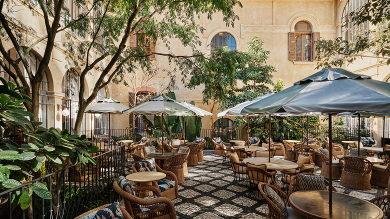 The open-air terrace restaurant, surrounded by green foliage and trees, at Soho House São Paulo, a members-only club located in Brazil