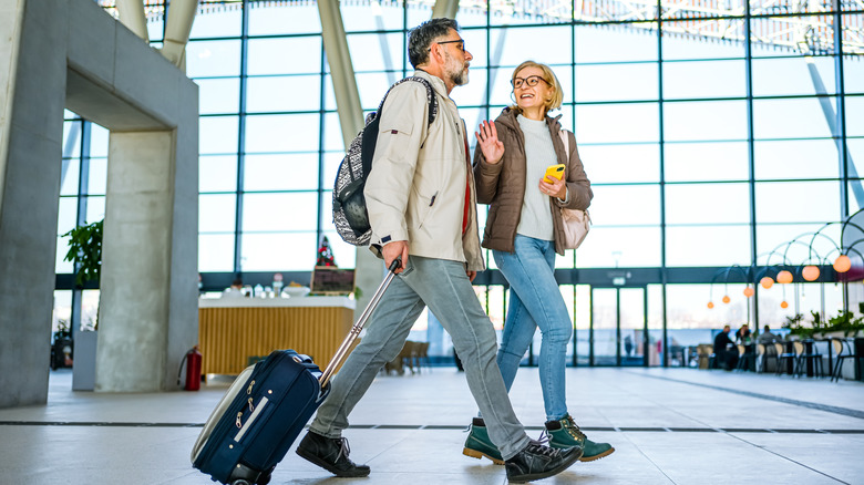 Couple walking through an airport