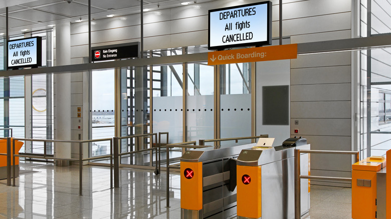 Empty airport gate with canceled flights sign