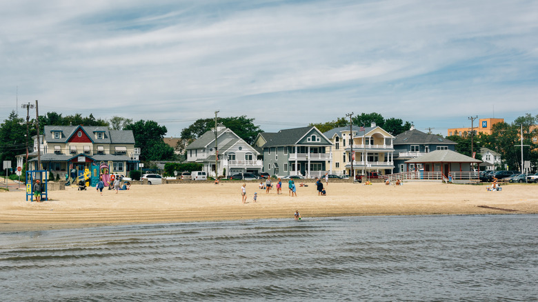 People playing and walking along the sand at William Morrow Beach in Somers Point