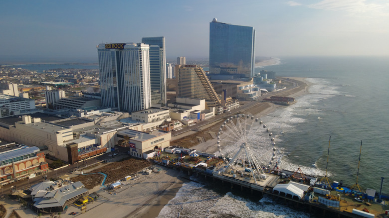 Towering casino hotels and resorts overlooking the ocean, beach, and amusement park on the pier in Atlantic City.