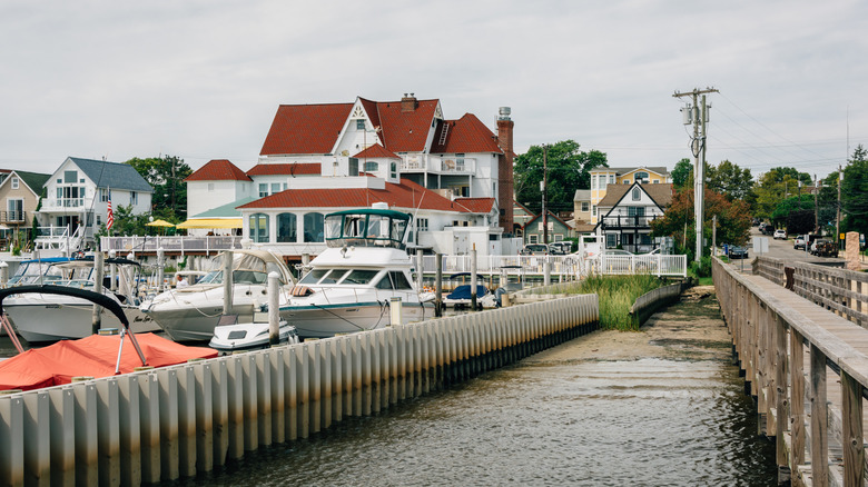 Boats docked at a marina near a pier and large houses in Somers Point