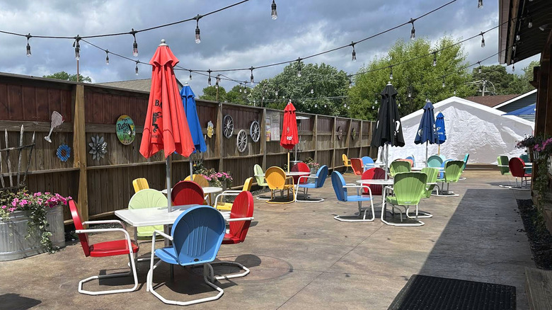 Colorful metal chairs around square tables outside at Sportsman's Bar & Grill in Somerset, Wisconsin