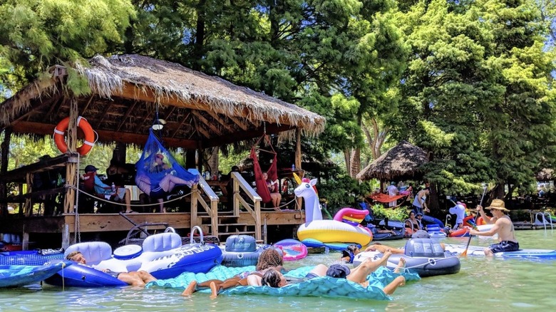 Guests lounge in a cabana and soak up the sun at Son's Island, Texas