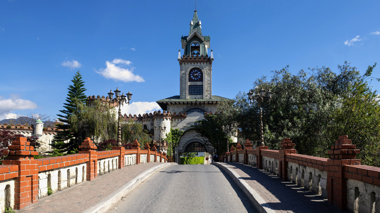 A bridge over the river leads to the historic City Gate of Loja, Ecuador