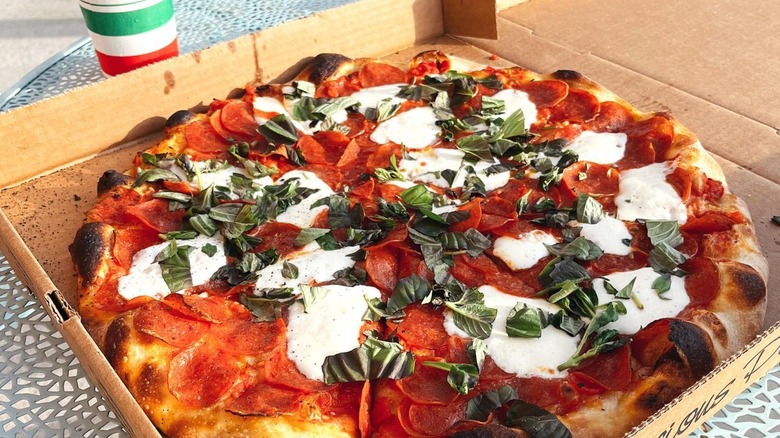 Pepperoni pizza with mozzarella slices in box