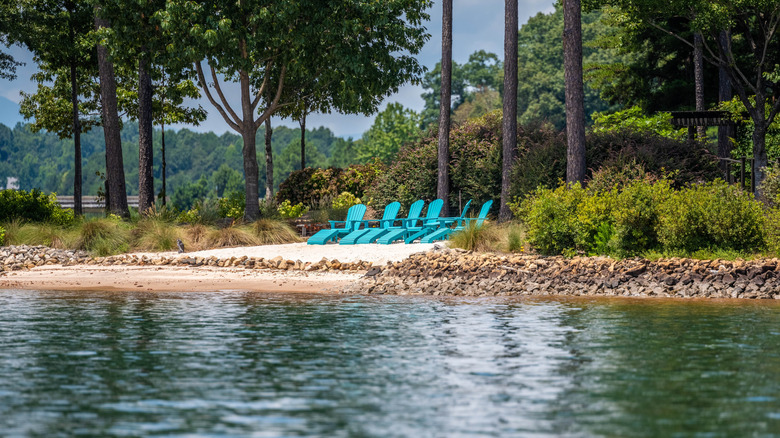 Bright recliner chairs along a lakefront
