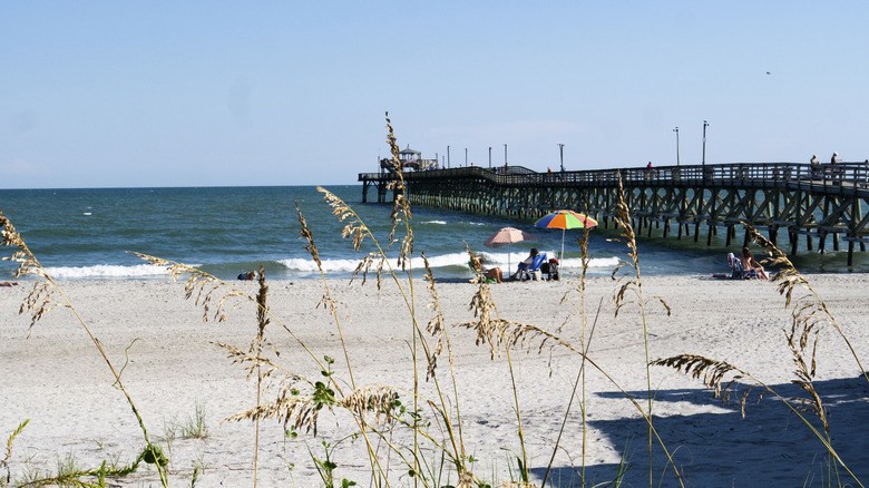 Sand beach with wooden pier