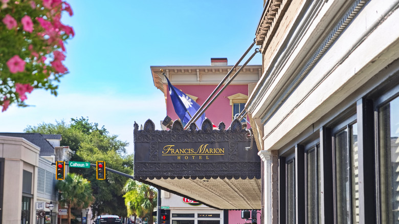 street view of Francis Marion Hotel entrance with city in background