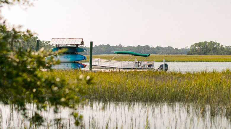 Boats and kayaks in the water on the Kiawah River in the salt marsh