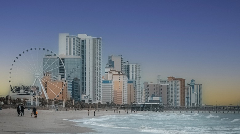 Myrtle Beach shoreline with high rises, a ferris wheel and hazy morning sky