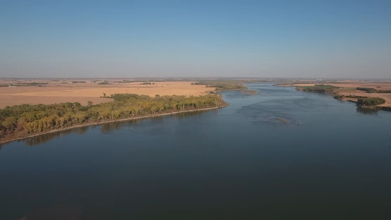 Missouri River, lined by trees, near Elk Point