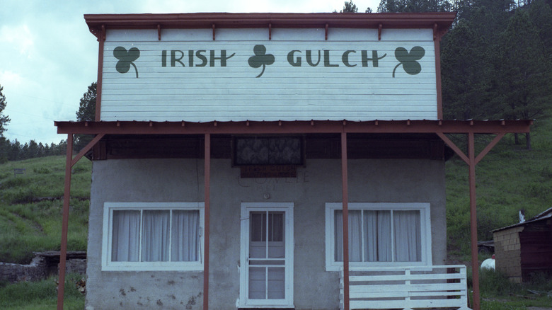 Irish Gulch green sign white clapboard building in Rochford