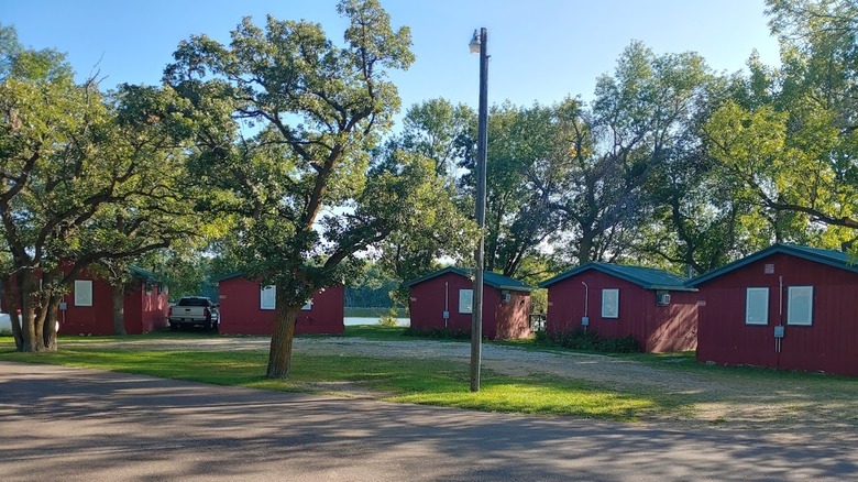 A view of several cabins at Roy Lake State Park with the lake in the background