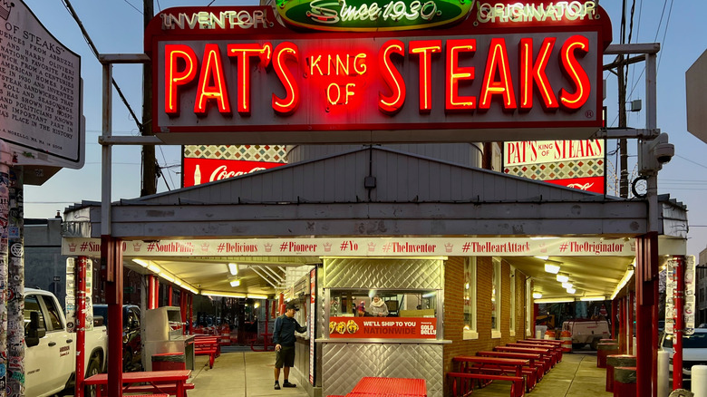 The front of Pat's King of Steaks bears a neon sign and service window in Philadelphia, Pennsylvania