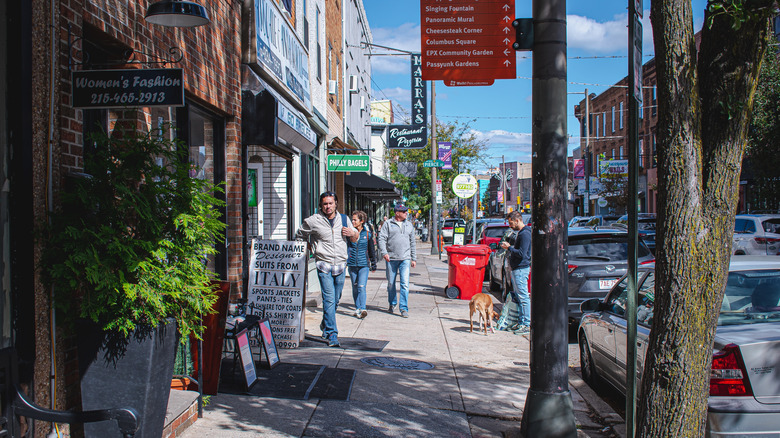 People walk down a sidewalk in East Passyunk, Philadelphia