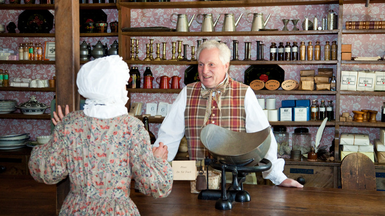 Actors recreating a scene in a 1900s country store at Old Sturbridge Village.