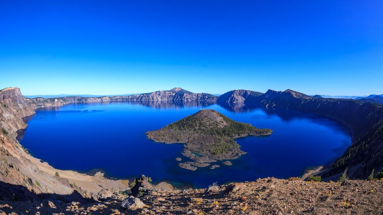 An island rises from a lake in the Crater Lake National Park, Oregon