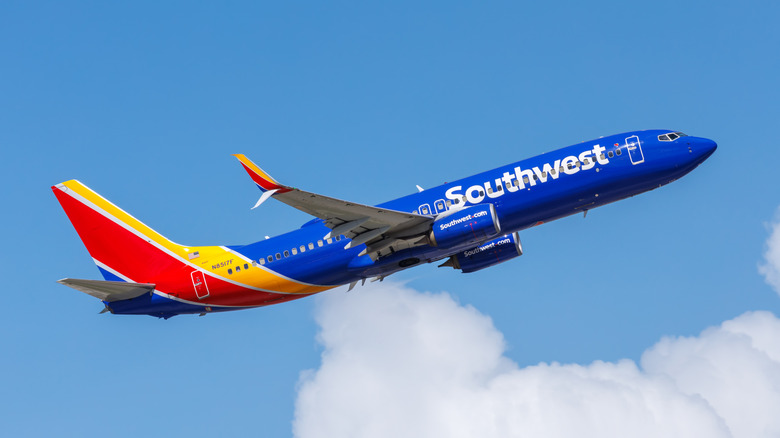 A Southwest airline flies through the sky on a clear day