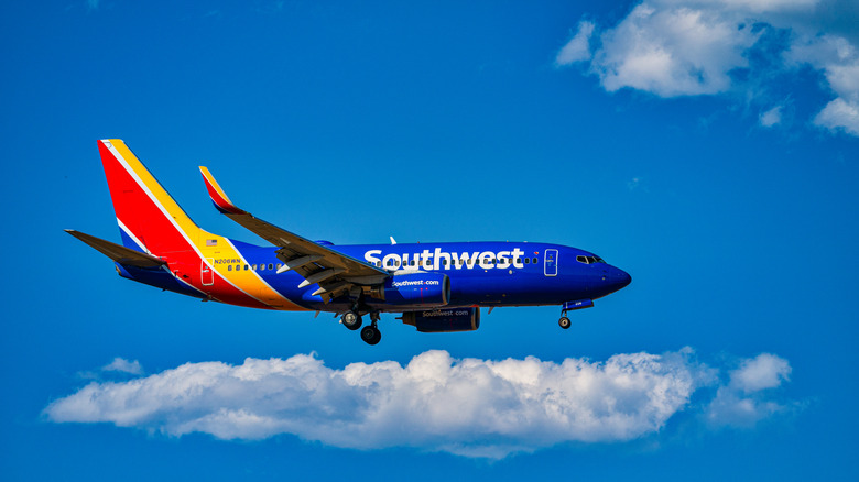Southwest airplane among clouds and a blue sky