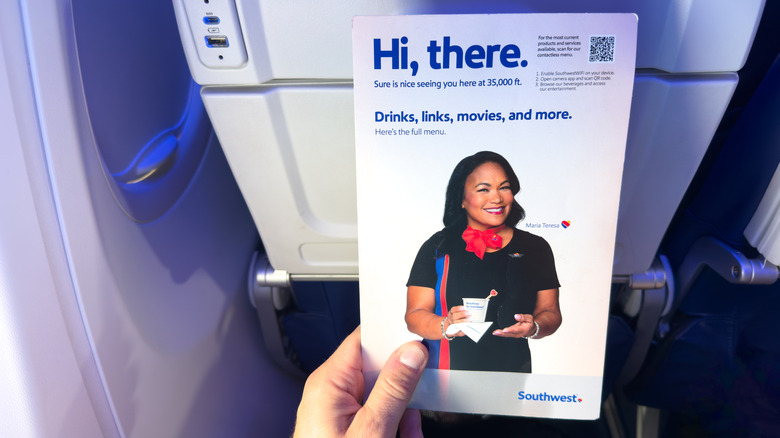 Holding a Southwest Airlines welcome pamphlet on board