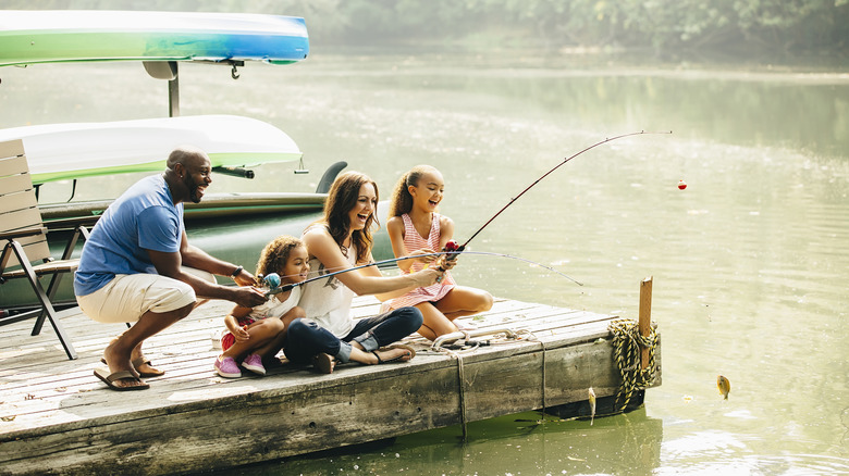 Family of four fishing on pier