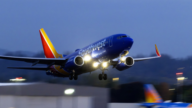 A Southwest Airlines flight takes off from Portland at dusk