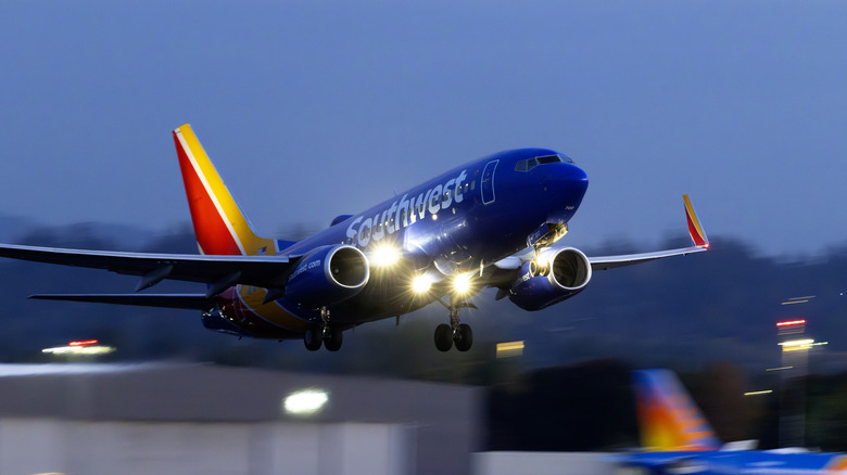 A Southwest Airlines flight takes off from Portland at dusk