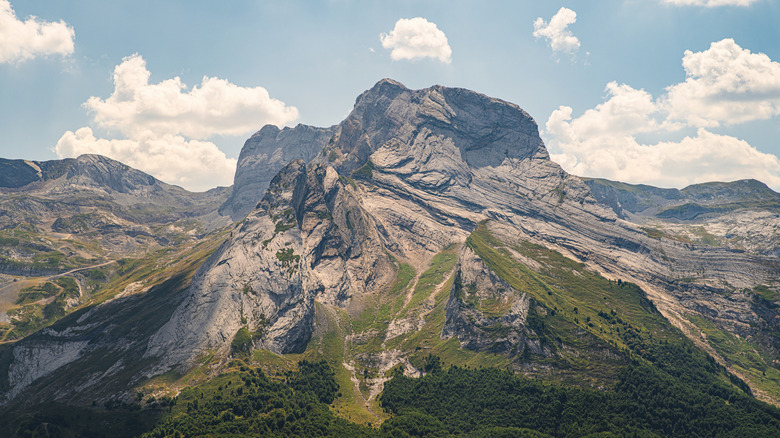 Spanish Pyrenees mountain peak against a cloudy blue sky