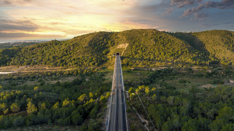 Railway running through a lush valley in Spain