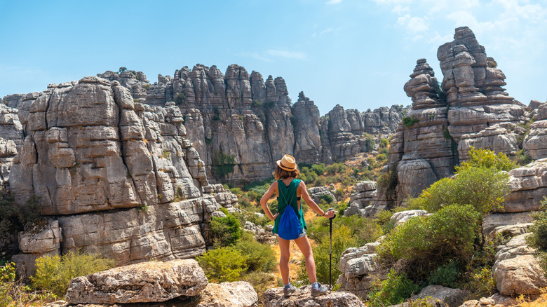woman standing on rock and looking at Torcal de Antequera, Spain