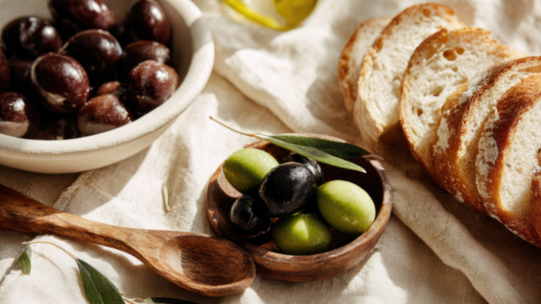 Table setting with bread, olives, and olive oil