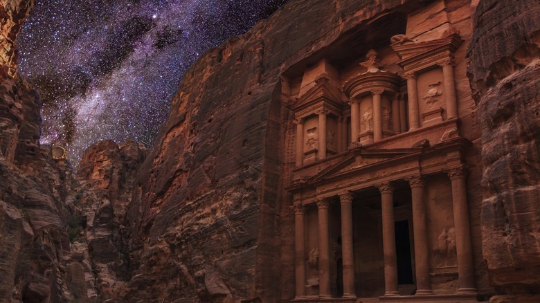 Nighttime image of The Treasury (Al Khazneh), the most photographed site at the ancient city of Petra in southern Jordan, with the Milky Way visible in the sky above