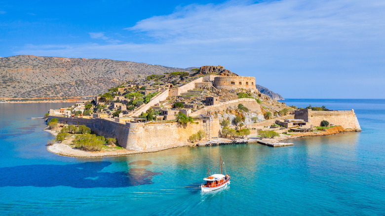 A small Greek island with large stone walls and ancient ruins