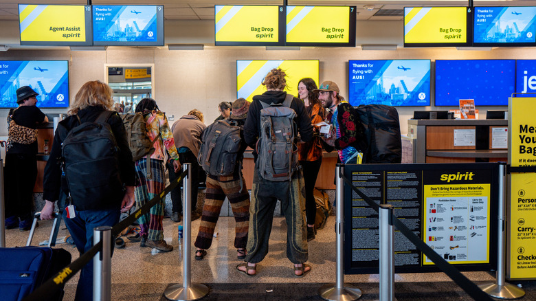 People in line at a Spirit Airlines airport counter